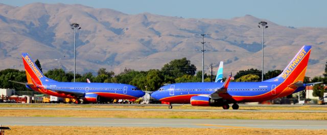 Boeing 737-700 (N274WN) - "FACE OFF" .. While N274WN (On Left) is taxiing to 30R for take off .. N926WN (Right) is on 30R during its take off ,, Captured in one shot.