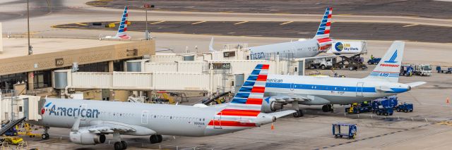 Airbus A319 (N744P) - An American Airlines A319 in Piedmont retro livery parked at PHX on 2/13/23, the busiest day in PHX history, during the Super Bowl rush. Taken with a Canon R7 and Canon EF 100-400 II L lens.