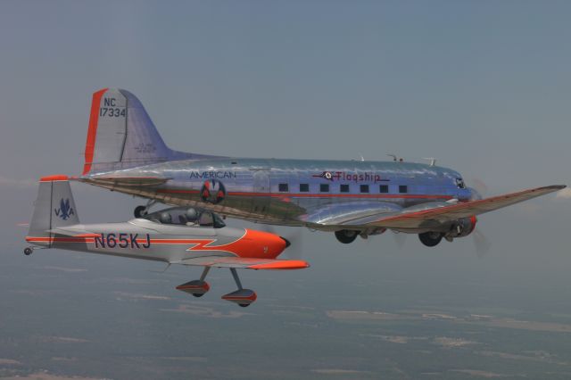 Vans RV-8 (N65KJ) - American Airlines First Officer Kelly Jeffries flying her RV-8 Fifinella (built by her Continental Airlines Pilot husband) in formation with the Captain Shiela (American Airlines Flight Attendant) flying the Flagship Detroit; American Airlines very first DC-3, for the Warbird Arrival into Sun-n-fun 2006.  Photo taken by Eileen Roberts in another RV-8 flown by American Airlines Captain Ted Roberts.