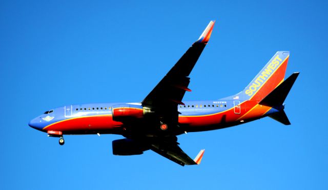 Boeing 737-700 (N222WN) - Southwest Airlines "Green Jet" on final 30R    The green aircraft uses environmentally friendly materials to make the airplane almost 520 pounds lighter. The reduced weight will save 10,000 gallons of fuel per year. Some of the materials include carpet and seat coverings never before used on commercial aircraft. The carpet is 10 percent lighter than current carpet used and took two hours less to install. Two seat covers are being tested, one of synthetic leather, the other of man-made composition leather using recycled materials. The aircraft features a lighter-weight life vest pouch.