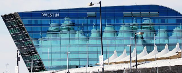 — — - New Westin hotel at DIA reflecting the canopy of the main terminal.