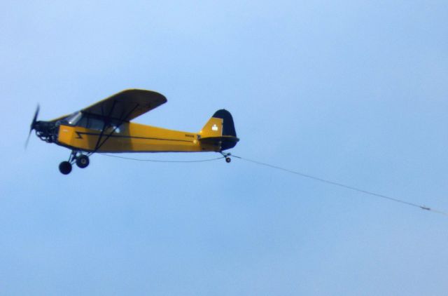 N40936 — - Shown here is a Piper J3C-65 Cub Special off the coast of Monmouth NJ currently set up for towing a banner in the Summer of 2017.  These aircraft were built between 1937 and 1947 by Piper.