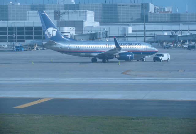 Boeing 737-800 (XA-NAM) - The other airline with a stainless steel livery spotted outside terminal D. 
