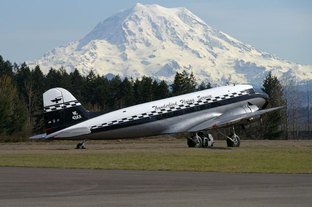 Douglas DC-3 (N353MM) - Seen basking in the springtime sun is this classic DC3. In the background is a snow capped, Mount Rainier.