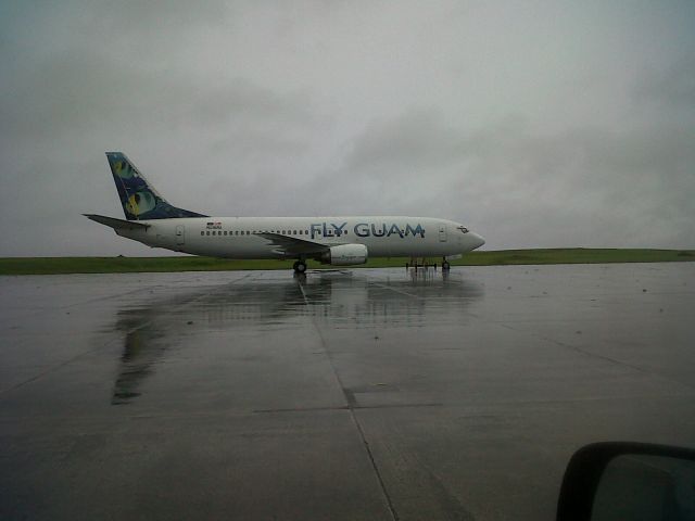 Boeing 737-700 — - Fly Guam 737 prep for taxi to boarding gate on a rainy PGUM day