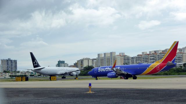 Boeing 737-900 (N8678E) - Southwest B737-900 and United B767-400 waiting for landing traffic at SJU RWY 8