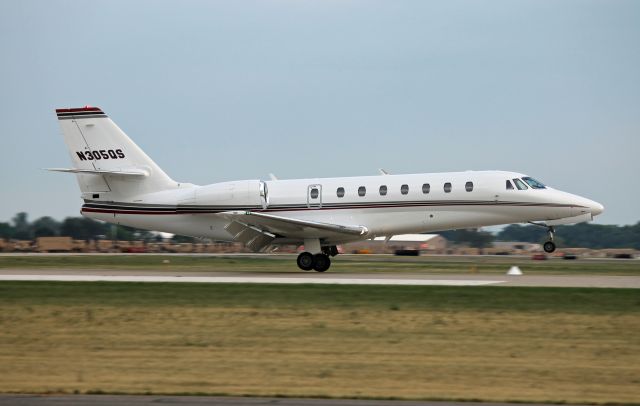 Cessna Citation Sovereign (N305QS) - A NetJets Sovereign touches down on runway 27 at Oshkosh, bringing Steve Miller into town for a concert the following night. Pictured during EAA AirVenture 2012.