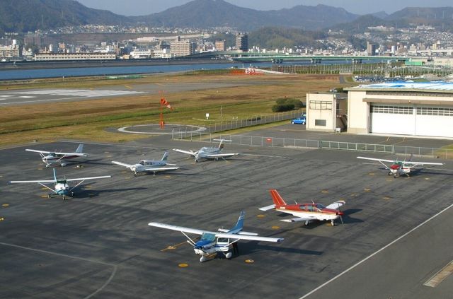 — — - Ramp as seen from the control tower of Hiroshima-Nishi airport