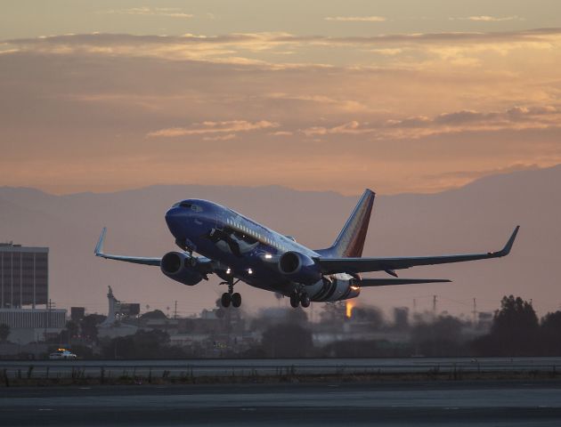 Boeing 737-700 (N280WN) - The Southwest/Seaworld penguins leave the LA Zoo polar bears behind at Los Angeles, California USA. This plane is making a westerly departure from runway 24L, LAX, 06:34 am, 6 September 2013