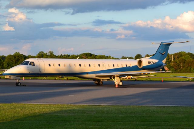 Embraer ERJ-145 (N47VA) - (NASCAR Victory Air) at KJQF with Charlotte Motor Speedway in the background - 5/30/20