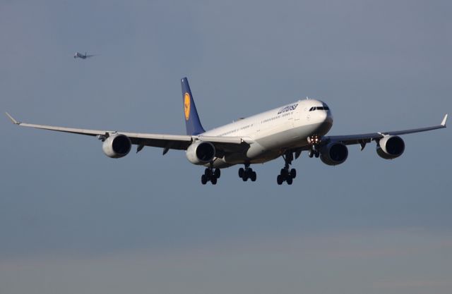 Airbus A340-600 (D-AIHO) - Singapore 777-300ER in the background.