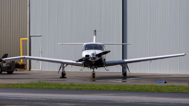 North American Rockwell Turbo Commander (680) (VH-MBM) - Seen here parked up with a damaged wing after wild weather blew the doors off the hangar it was stored in. They fell onto the aircraft causing the damage.