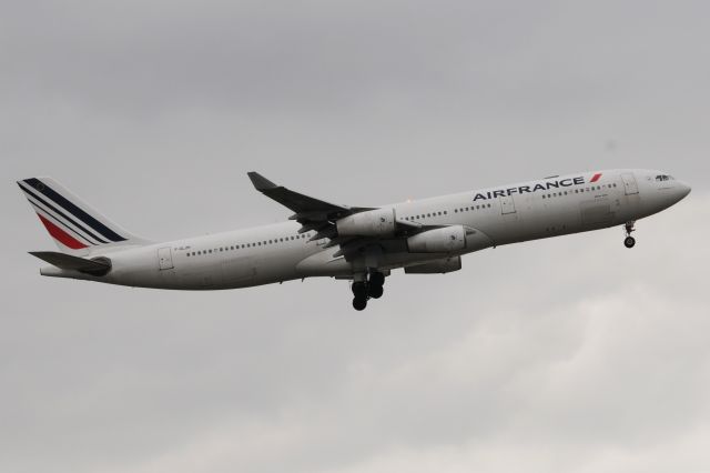 Airbus A340-300 (F-GLZK) - 22-R Arrival on an overcast day.