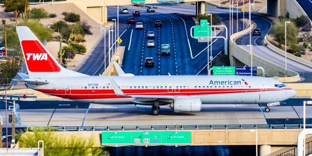 Boeing 737-800 (N915NN) - An American Airlines 737-800 in TWA retro livery taxiing at PHX on 2/28/23. Taken with a Canon R7 and Canon EF 100-400 L ii lens.