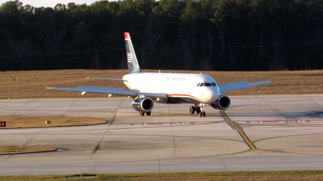 Airbus A320 (N669AW) - An American Airlines (US Airways livery) landing at Raleigh-Durham Intl. Airport. This was taken from the observation deck on January 17, 2016 at 4:52 PM. This is flight 2056 from CLT.