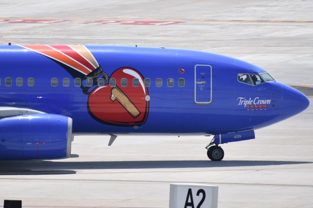 Boeing 737-700 (N409WN) - On top of the parking garage for Triple