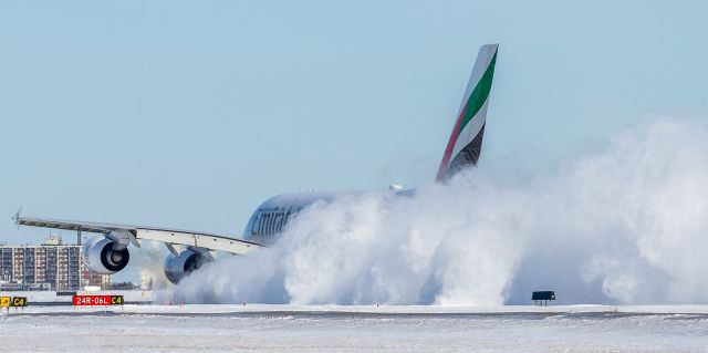 Airbus A380-800 (A6-EUJ) - EK242 gets underway down runway 06L at YYZ with the outboard engines kicking up snow as she goes!