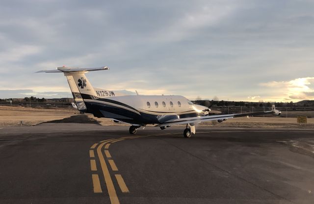 Pilatus PC-12 (N129JW) - Air Methods Medevac Pilatus waiting to depart 35L at APA as the sun sets.