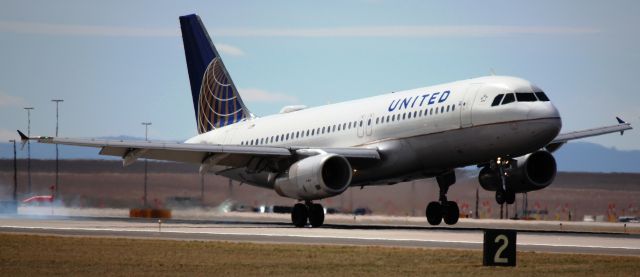 Airbus A320 (N431UA) - Smokey touchdown on 35L from coping with a crosswind.