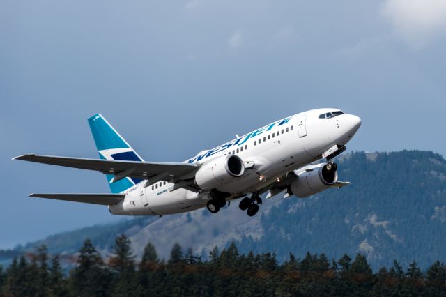 BOEING 737-600 (C-GWSJ) - Photographed departing runway 09 at Victoria Intl. Airport in BC, Canada