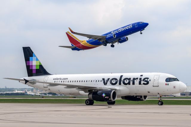 Airbus A320 (N513VL) - Taxiing to the Terminal with a Southwest 738 overhead