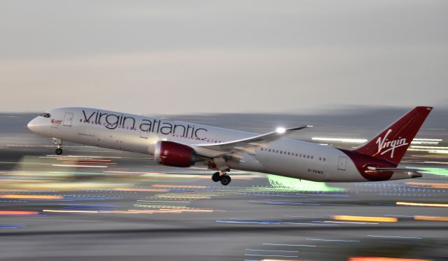 Boeing 787-9 Dreamliner (G-VOWS) - Apologies for the less than perfect exposure, this was a handheld pan at 200mm with a 1/10 sec exposure, I just thought it looked cool with the LED lights pulsing on the ground and the mood lighting visible inside the aircraft.