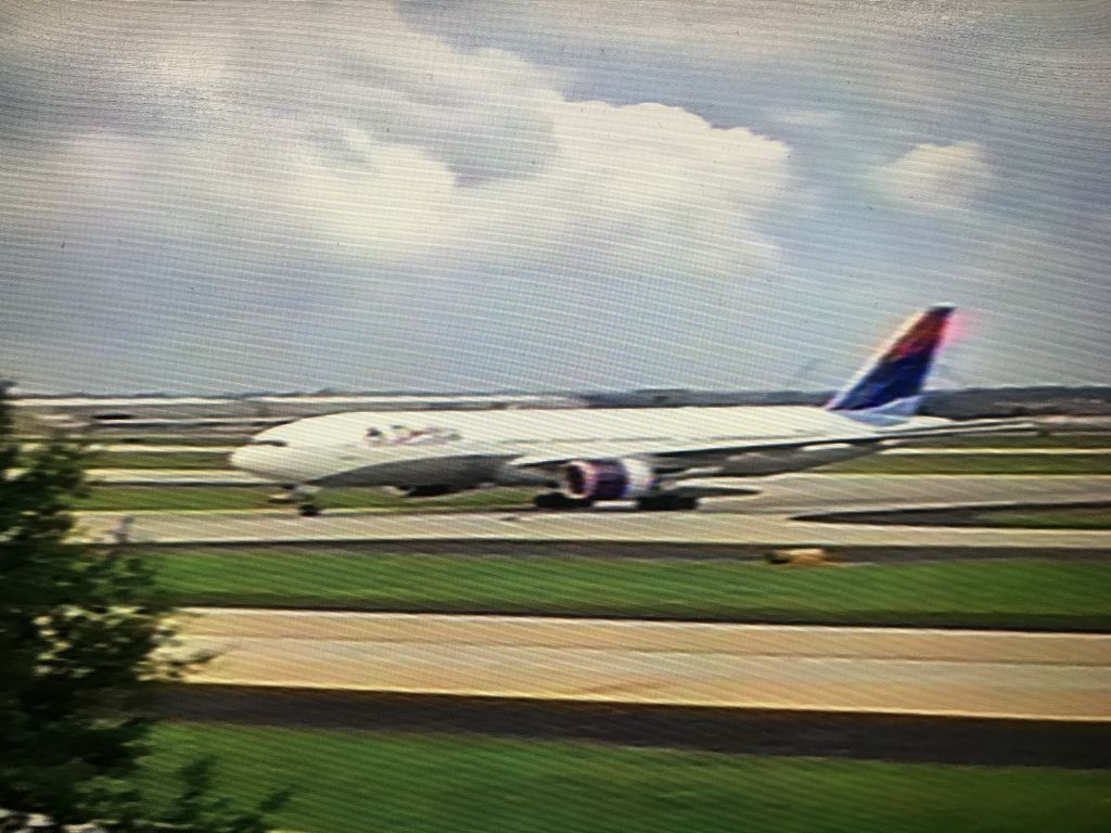 Boeing 777-200 — - Sorry for the poor quality.  Taken at ATL with a very old and basic digital camera somewhere around 2002/2003.  One of my earliest times plane spotting as a kid!