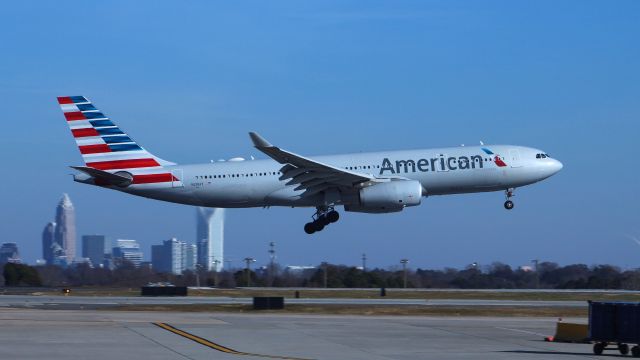 Airbus A330-300 (N291AY) - Taken from Concourse E at Charlotte, a nice view of the city in the background makes for a perfect spotting location.