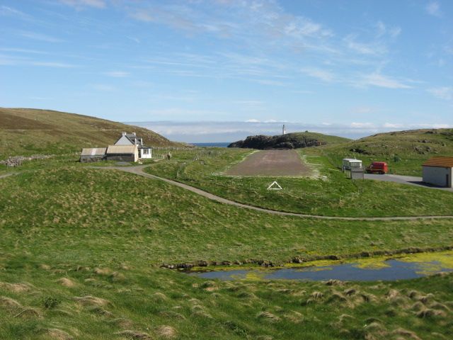 — — - AS view down the runway at Out Skerries Shetland UK. 1246ft gravel runway. The house on the left is available for rent