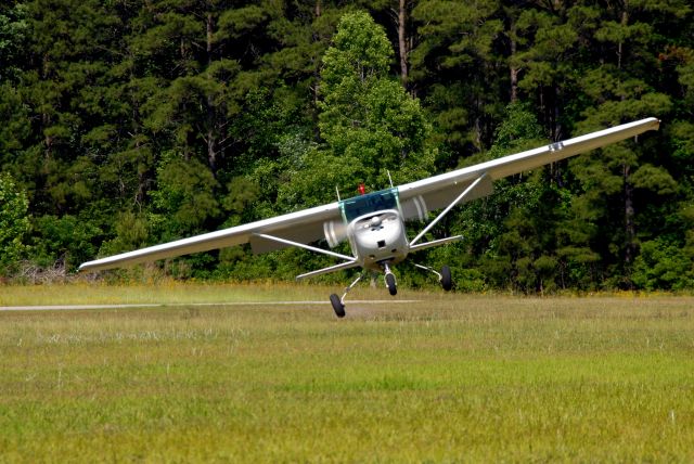 Cessna Commuter (N3936U) - Showing off the Nifty 50 on a short-field/soft-field demonstration flight, complete with 50 ft tall treelines on all sides of the runway and a road that crosses over one end of the runway.