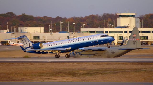 Canadair Regional Jet CRJ-700 (N169GJ) - United Express CRJ taking off with a C130 from the Tennessee Air Guard Nashville in the background