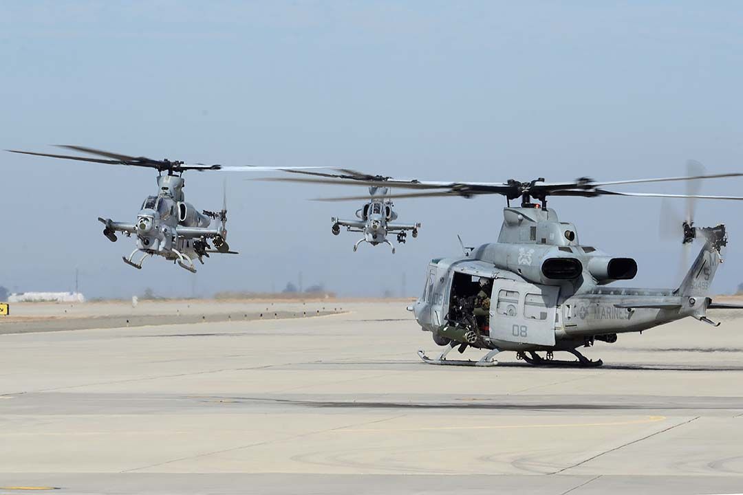 16-8799 — - Bell-Boeing UH-1W Huey BuNo 168499 of HMLA-369 Gunfighters prepares for take-off as AH-1Z Viper BuNo 168799 and AH-1Z Viper BuNo 168002 of HMLA-267 Stingers move to their parking positions at NAF el Centro on February 19, 2015. Both squadrons are based at MCAS Camp Pendleton. 