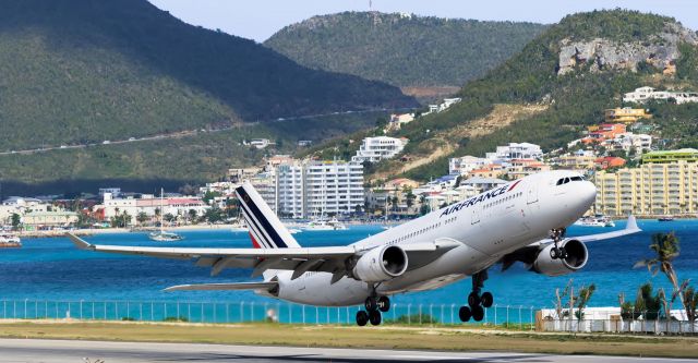 Airbus A330-200 (F-GZCL) - Air France Airbus A332 F-GZCL departing TNCM St Maarten on runaway 28 for Paris France. in the back ground we have the Kimsha beach area with Atrium hotel.