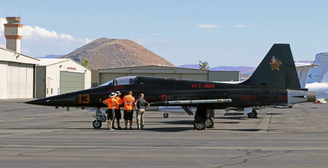 Northrop RF-5 Tigereye (76-1578) - Four Stellar Aviation FBO ramp agents bid goodbye to 761578, a Northrop F-5N Tiger that has just "changed hands." Previously flown by the VFC-13 "Fighting Saints" at nearby NAS Fallon, this warbird is headed south with a new tail design and new unit title which identifies its new unit of assignment.br /br /United States Navy Northrop F-5N Tiger (761578)br /VFC-204 (Fleet Composite Squadron Two Oh Four) "River Rattlers"br /Naval Air Station/Joint Reserve Base New Orleans (NAS/JRB New Orleans)br /br /VFC-204, formerly VFA-204, is in the process of being redesignated from a Strike Fighter Squadron to a Fleet Composite Squadron. As part of the change, the VFC-13 Fighting Saints at NAS Fallon are losing all of its F-5s (which are being replaced by ex-USAF F-16s), and VFC-13's F-5s are all being transferred to the "new" VFC-204.