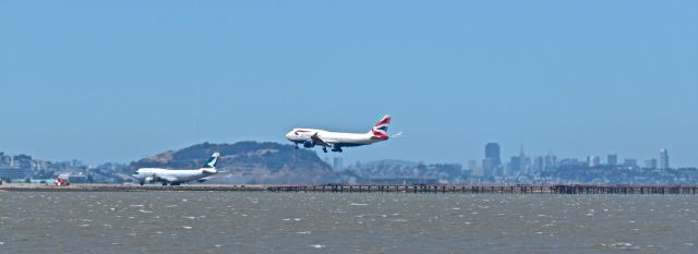 Boeing 747-400 (G-BYGC) - British Airways 747 arriving from London Heathrow and a Cathay Pacific 747 leaving for Hong Kong. Taken 6/16/13 at San Francisco International Airport.
