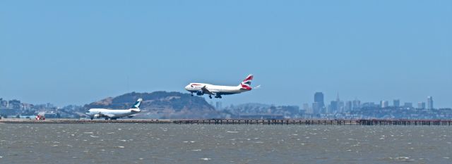 Boeing 747-400 (G-BYGC) - British Airways 747 arriving from London Heathrow and a Cathay Pacific 747 leaving for Hong Kong. Taken 6/16/13 at San Francisco International Airport.