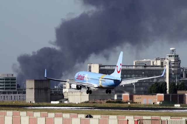 Boeing 737-800 (OO-JAF) - there was a fire @ some building on the airport 