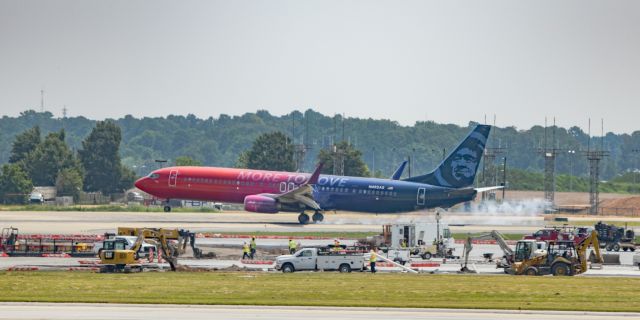 Boeing 737-700 (N493AS) - N493AS lands on 9R, while construction continues on an adjacent taxiway. Taken 8/25/18