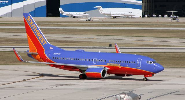 Boeing 737-700 (N227WN) - Taxiing to gate after arrival on 12R.