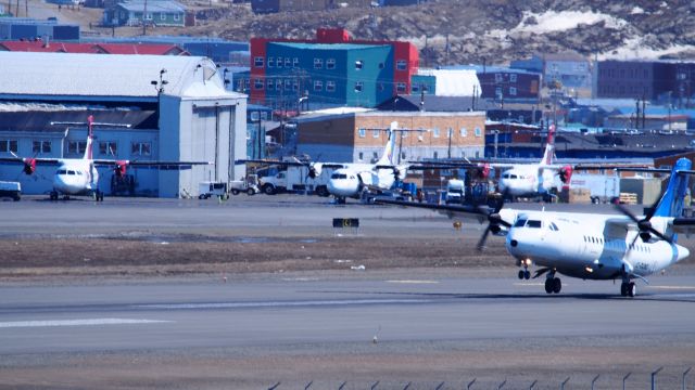 Aerospatiale ATR-42-300 (C-GUNO) - C-GUNO. ATR-42-300, Aerospatiale, landing at the Iqaluit airport, June 12, 2018, with a fleet of ATRs in the background.