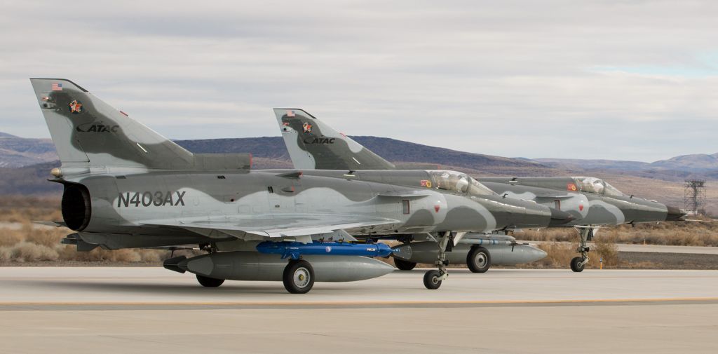 IAI Kfir (N403AX) - A pair of Airborne Tactical Advantage Company (ATAC) IAI* Kfir-C2s (N403AX with N402AX behind it) roll south on NAS Fallons Alpha taxiway as they taxi toward runway 31R for takeoff to participate as aggressor aircraft in a training exercise.  (*Info note:  IAI is Israel Aircraft Industries.)