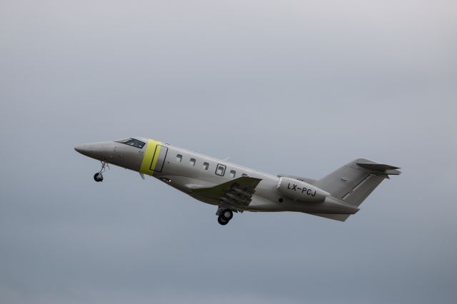 Pilatus PC-24 (LX-PCJ) - Pilatus PC-24 Registration LX-PCJ (ICAO24 4D02E9) airborne after take off from Manchester Airport 26th March 23.