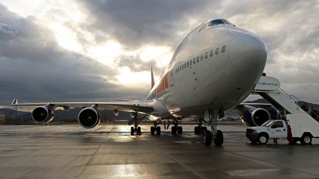 Boeing 747-400 (N465MC) - Atlas Air (GTI) B744, N465MC, on the Atlantic Aviation ramp as the dawn sunlight begins to find its way to shine through dark clouds. The rain had stopped falling about 45 minutes before this pic was taken.br /This gorgeous Queen of the Skies was preparing to depart for a flight to Cherry Point (KNKT). Some of the hundreds of US Marines boarding this flight had been stranded here in Reno since Saturday when an Omni Air International Triple 7 that was enroute to pick them up was forced to divert to Dallas. Those Marines had been given rooms at a downtown Reno Casino, and the ones I spoke with did not seem to be very upset about being stranded in Reno for three days.