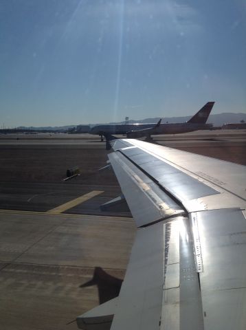 Airbus A319 (N813AW) - Holding short of the runway with a US Airways 757-200 on the takeoff roll.