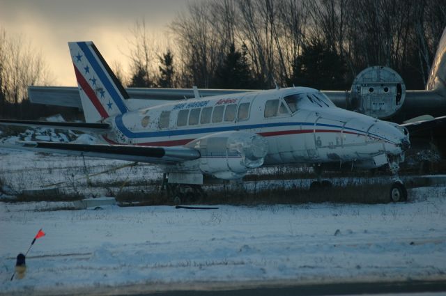 Beechcraft Airliner (C-GNAL) - Beechcraft Model 99 Airliner (C/N: U-5) sitting derelict at CYPQ/YPQ (Feb 2, 2017). This airframe has the Bar Harbor Airlines livery but was left derelict at CYPQ since at least 1993. You may also notice the wing of a DC-3 in the background