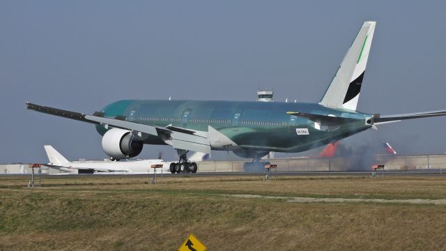 BOEING 777-300 (A6-ENA) - BOE923 touching down on runway 34L to complete its maiden flight on 9/14/12. (LN:10zz c/n 41082).