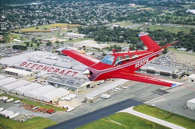 Beechcraft 35 Bonanza (N590PM) - 1969 V35A Bonanza over factory with original paint scheme.