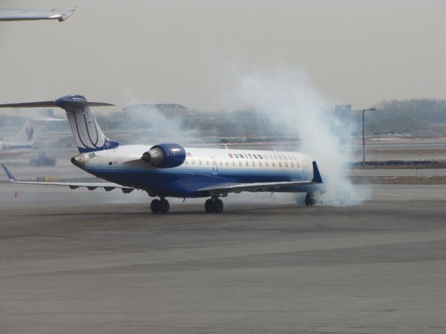 Canadair Regional Jet CRJ-700 (N153GJ) - I was busy watching 747s when I saw a bunch of smoke.  I dont think anything truly bad happened, just a bunch of smoke.  The plane continued its taxi to the runway.