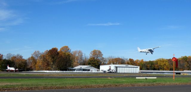 Cessna Skyhawk (N2373M) - Shortly after departure is this 2007 Cessna 172S Skyhawk SP in the Autumn of 2022. The flight office and main hangar are also shown.