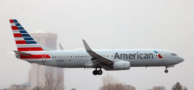 Boeing 737-800 (N988NN) - The storm was just about over but there was still some snow falling around 10:40 AM when American's N988NN began to flare out to land on Runway 34L at the end of a DFW-RNO trip.